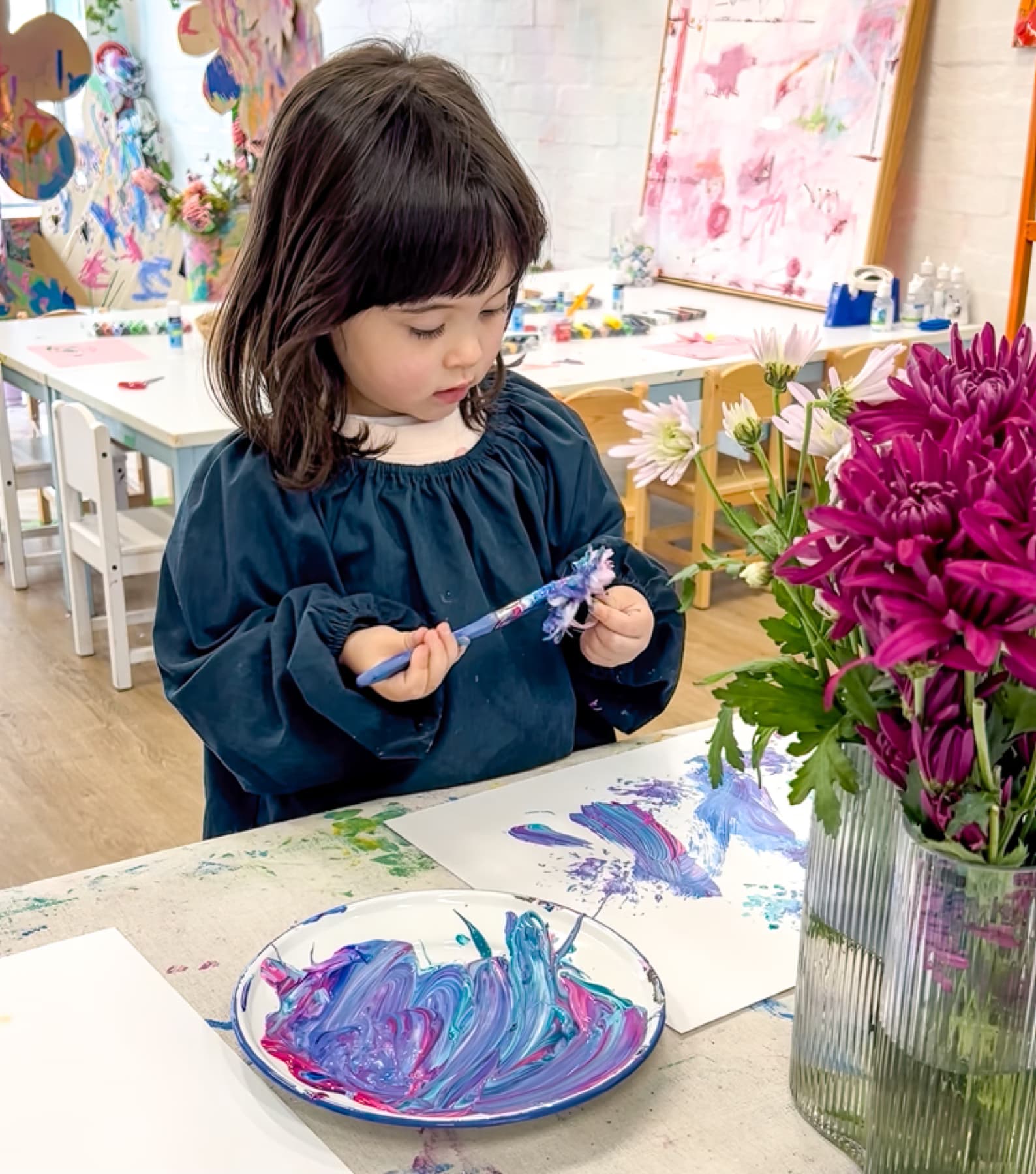 Young girl immersed in painting at Smudge Artspace
