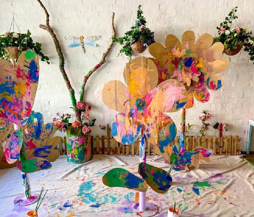 The Inside Days cover photo, a garden of painted cardboard flowers in the studio